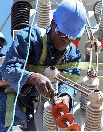 Johannesburg, South Africa, 04/11/2012, Electricians working on high voltage power lines. Highly skilled workmen servicing the electricity grid