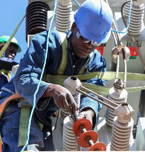 Johannesburg, South Africa, 04/11/2012, Electricians working on high voltage power lines. Highly skilled workmen servicing the electricity grid